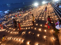 Devotees light traditional oil lamps as they celebrate the Hindu festival of 'Dev Deepawali' at Sangam, the confluence of the rivers Ganges,...