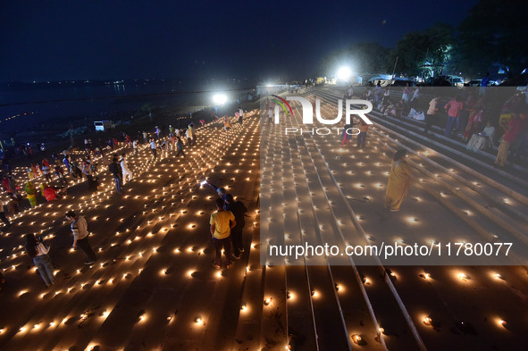 Devotees light traditional oil lamps as they celebrate the Hindu festival of 'Dev Deepawali' at Sangam, the confluence of the rivers Ganges,...