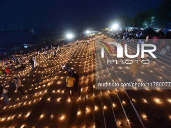 Devotees light traditional oil lamps as they celebrate the Hindu festival of 'Dev Deepawali' at Sangam, the confluence of the rivers Ganges,...