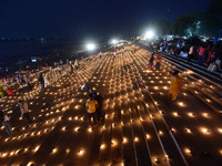 Devotees light traditional oil lamps as they celebrate the Hindu festival of 'Dev Deepawali' at Sangam, the confluence of the rivers Ganges,...