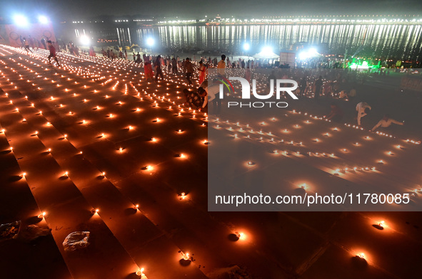 Devotees light traditional oil lamps as they celebrate the Hindu festival of 'Dev Deepawali' at Sangam, the confluence of the rivers Ganges,...