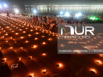 Devotees light traditional oil lamps as they celebrate the Hindu festival of 'Dev Deepawali' at Sangam, the confluence of the rivers Ganges,...