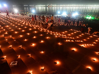 Devotees light traditional oil lamps as they celebrate the Hindu festival of 'Dev Deepawali' at Sangam, the confluence of the rivers Ganges,...