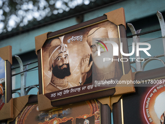 A framed photo of Guru Nanak Ji is sold near a Gurudwara on the occasion of Guru Nanak Jayanti in Guwahati, Assam, India, on November 15, 20...