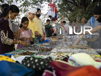 Sikh people buy religious items at a stall near a Gurudwara on the occasion of Guru Nanak Jayanti in Guwahati, Assam, India, on November 15,...