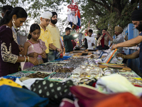 Sikh people buy religious items at a stall near a Gurudwara on the occasion of Guru Nanak Jayanti in Guwahati, Assam, India, on November 15,...