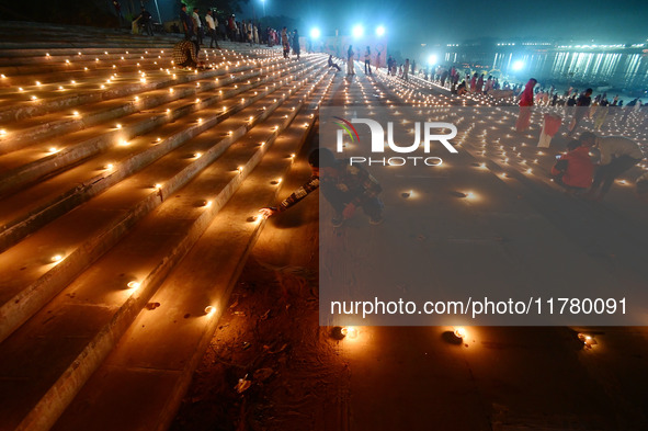 Devotees light traditional oil lamps as they celebrate the Hindu festival of 'Dev Deepawali' at Sangam, the confluence of the rivers Ganges,...