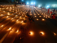 Devotees light traditional oil lamps as they celebrate the Hindu festival of 'Dev Deepawali' at Sangam, the confluence of the rivers Ganges,...