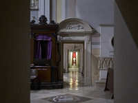 This image shows the wooden pastoral symbols of Italian Bishop Tonino Bello, including his mitre, pastoral staff, wooden cross, and ring. Bi...