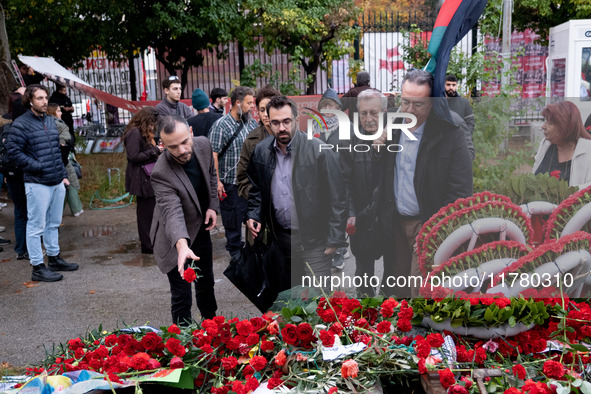 A man lays a carnation on a monument inside the Athens Polytechnic during the celebration of the 51st anniversary of the Polytechnic uprisin...