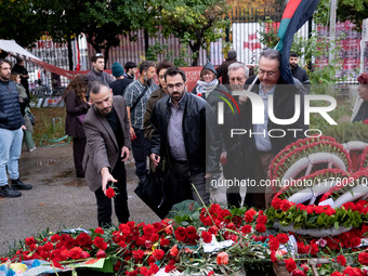 A man lays a carnation on a monument inside the Athens Polytechnic during the celebration of the 51st anniversary of the Polytechnic uprisin...