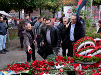 A man lays a carnation on a monument inside the Athens Polytechnic during the celebration of the 51st anniversary of the Polytechnic uprisin...