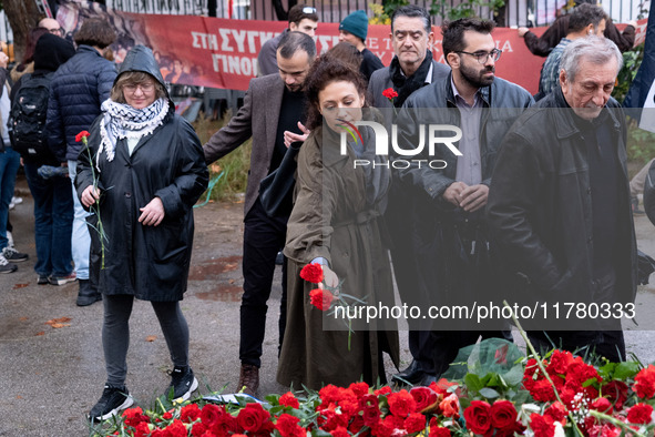 A woman lays a carnation on a monument inside the Athens Polytechnic during the celebration of the 51st anniversary of the Polytechnic upris...