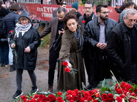 A woman lays a carnation on a monument inside the Athens Polytechnic during the celebration of the 51st anniversary of the Polytechnic upris...