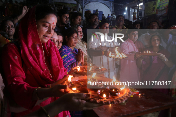 Union Minister and West Bengal State BJP President Sukanta Majumder and Hindu women devotees perform rituals at a ghat on the banks of the H...