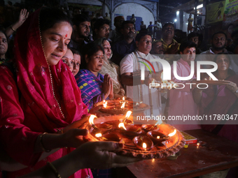 Union Minister and West Bengal State BJP President Sukanta Majumder and Hindu women devotees perform rituals at a ghat on the banks of the H...