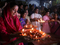 Union Minister and West Bengal State BJP President Sukanta Majumder and Hindu women devotees perform rituals at a ghat on the banks of the H...