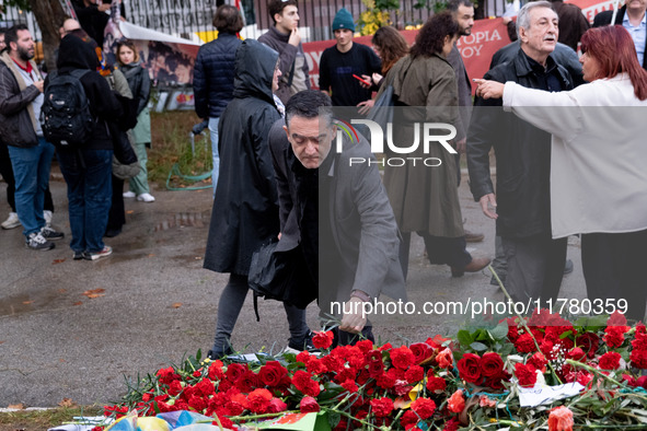 A man lays a carnation on a monument inside the Athens Polytechnic during the celebration of the 51st anniversary of the Polytechnic uprisin...