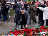 A man lays a carnation on a monument inside the Athens Polytechnic during the celebration of the 51st anniversary of the Polytechnic uprisin...