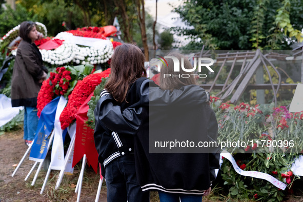 Two girls hold each other near a monument inside the Athens Polytechnic during the celebration of the 51st anniversary of the Polytechnic up...