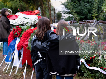 Two girls hold each other near a monument inside the Athens Polytechnic during the celebration of the 51st anniversary of the Polytechnic up...