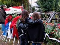 Two girls hold each other near a monument inside the Athens Polytechnic during the celebration of the 51st anniversary of the Polytechnic up...