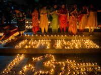 Devotees light oil lamps and chant prayers at a riverside of the Ganges in Kolkata, India, on November 15, 2024, during the Dev Deepavali ce...