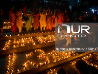 Devotees light oil lamps and chant prayers at a riverside of the Ganges in Kolkata, India, on November 15, 2024, during the Dev Deepavali ce...