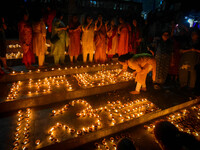 Devotees light oil lamps and chant prayers at a riverside of the Ganges in Kolkata, India, on November 15, 2024, during the Dev Deepavali ce...