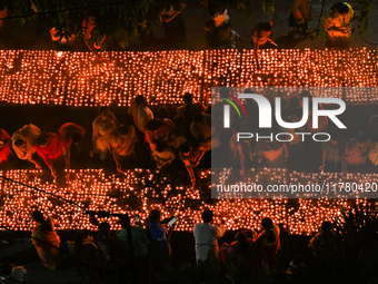 Hindu devotees light clay lamps in front of a temple on the occasion of Kartik Purnima celebrations in Hyderabad, India, on November 15, 202...