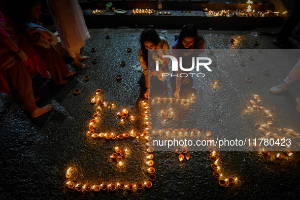 Devotees light oil lamps at the riverside of the Ganges in Kolkata, India, on November 15, 2024, during the Dev Deepavali celebration in the...