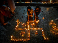 Devotees light oil lamps at the riverside of the Ganges in Kolkata, India, on November 15, 2024, during the Dev Deepavali celebration in the...