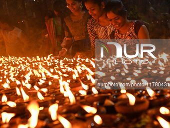 Hindu devotees light clay lamps in front of a temple on the occasion of Kartik Purnima celebrations in Hyderabad, India, on November 15, 202...