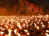 Hindu devotees light clay lamps in front of a temple on the occasion of Kartik Purnima celebrations in Hyderabad, India, on November 15, 202...