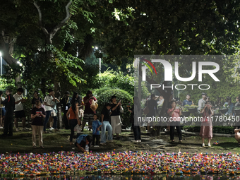 People float Krathong offerings at a park lake during the Thai annual Loy Krathong festival in Bangkok, Thailand, on November 15, 2024. The...