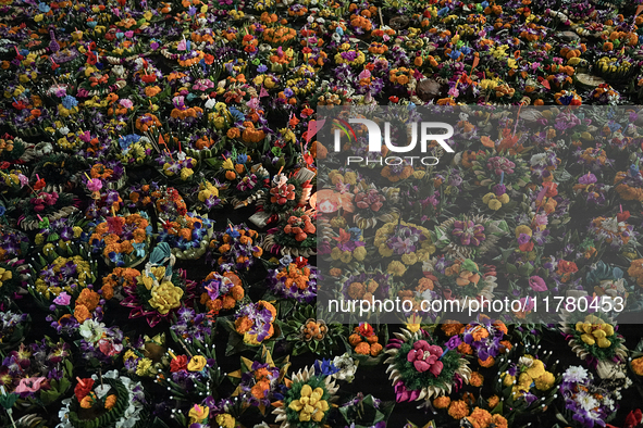 Floating Krathongs, baskets made with leaves and flowers, float in a park lagoon during the Thai annual Loy Krathong festival in Bangkok, Th...