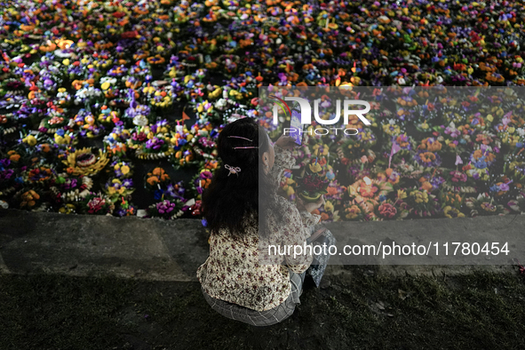 People float Krathong offerings at a park lake during the Thai annual Loy Krathong festival in Bangkok, Thailand, on November 15, 2024. The...