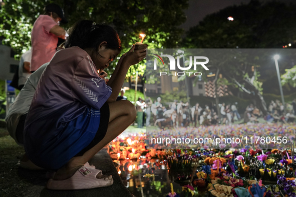 People float Krathong offerings at a park lake during the Thai annual Loy Krathong festival in Bangkok, Thailand, on November 15, 2024. The...