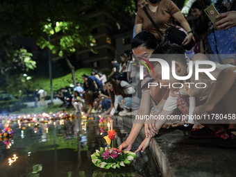 People float Krathong offerings at a park lake during the Thai annual Loy Krathong festival in Bangkok, Thailand, on November 15, 2024. The...