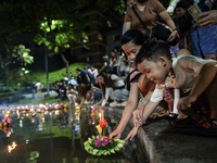 People float Krathong offerings at a park lake during the Thai annual Loy Krathong festival in Bangkok, Thailand, on November 15, 2024. The...