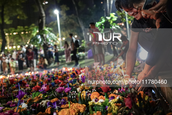 People float Krathong offerings at a park lake during the Thai annual Loy Krathong festival in Bangkok, Thailand, on November 15, 2024. The...