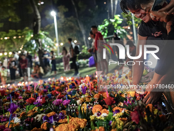 People float Krathong offerings at a park lake during the Thai annual Loy Krathong festival in Bangkok, Thailand, on November 15, 2024. The...