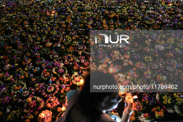 People float Krathong offerings at a park lake during the Thai annual Loy Krathong festival in Bangkok, Thailand, on November 15, 2024. The...