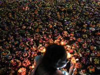 People float Krathong offerings at a park lake during the Thai annual Loy Krathong festival in Bangkok, Thailand, on November 15, 2024. The...