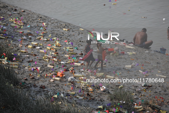 Girls collect items thrown by devotees as religious offerings after the celebrations of the 'Boita Bandana,' also known as ''Danga Bhasa,''...