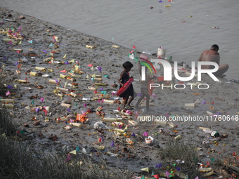 Girls collect items thrown by devotees as religious offerings after the celebrations of the 'Boita Bandana,' also known as ''Danga Bhasa,''...