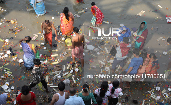 People collect items thrown by devotees as religious offerings after the celebrations of the 'Boita Bandana,' also known as 'Danga Bhasa,' o...