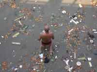 A man offers prayer among the items thrown by devotees as religious offerings after the celebrations of the 'Boita Bandana,' also known as '...