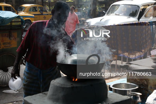 A man prepares food using coal ovens on the banks of the river Ganges in Kolkata, India, on November 15, 2024. The Union Environment Ministr...