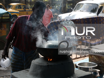 A man prepares food using coal ovens on the banks of the river Ganges in Kolkata, India, on November 15, 2024. The Union Environment Ministr...